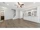 Open-concept area with a kitchen island, modern flooring, and staircase at 3465 Maple Valley Dr, Cumming, GA 30040