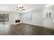Bright living room featuring a fireplace, sliding door, and door to patio, complemented by gray walls at 3465 Maple Valley Dr, Cumming, GA 30040