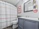 Bathroom featuring a striped shower curtain and blue vanity at 3822 Harris Nw Blvd, Kennesaw, GA 30144