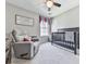 Bedroom with crib and rocker chair, with sign on the wall at 3822 Harris Nw Blvd, Kennesaw, GA 30144