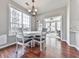 Bright breakfast nook features wood floors, a modern chandelier, and a door to the backyard at 3822 Harris Nw Blvd, Kennesaw, GA 30144