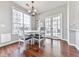 Bright breakfast nook features wood floors, a modern chandelier, and a door to the backyard at 3822 Harris Nw Blvd, Kennesaw, GA 30144