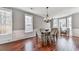 Inviting dining area featuring hardwood floors, wainscoting, large windows, and a stylish chandelier at 3822 Harris Nw Blvd, Kennesaw, GA 30144
