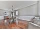 Elegant dining room with hardwood floors, wainscoting, modern chandelier, and ample natural light at 3822 Harris Nw Blvd, Kennesaw, GA 30144