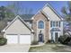 Charming two-story home boasts a stone facade, arched window, blue shutters, and a well-manicured lawn at 3822 Harris Nw Blvd, Kennesaw, GA 30144