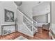 Bright foyer with gleaming hardwood floors, and staircase with white railings at 3822 Harris Nw Blvd, Kennesaw, GA 30144