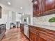 Well-appointed kitchen featuring granite countertops, dark wood cabinets, stainless steel appliances, and hardwood floors at 3822 Harris Nw Blvd, Kennesaw, GA 30144