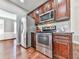 Modern kitchen boasts stainless steel appliances, dark wood cabinets, and hardwood floors at 3822 Harris Nw Blvd, Kennesaw, GA 30144
