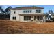 Rear view of a two-story home with a covered patio and large windows, set on a spacious lot at 456 Maypop Ln, Woodstock, GA 30188