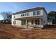 Two-story house featuring a covered patio and many large windows on a spacious lot at 456 Maypop Ln, Woodstock, GA 30188