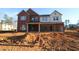 New construction two-story home featuring a two-car garage and a combination of brick and siding at 456 Maypop Ln, Woodstock, GA 30188