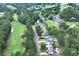 Aerial view of house with a pool, located on a golf course and tree-lined community at 6335 Hampton Creek Dr, Cumming, GA 30041