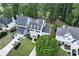 Aerial view of house and community with manicured lawns, mature trees and driveway at 6335 Hampton Creek Dr, Cumming, GA 30041