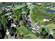 An aerial view of the golf course, clubhouse, tennis courts, swimming pool, and parking lot at 6335 Hampton Creek Dr, Cumming, GA 30041