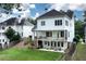 Back of house features multi-level deck, patio area with seating, grill, and fenced yard at 6335 Hampton Creek Dr, Cumming, GA 30041