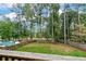 Enjoy a spacious backyard with a fenced in pool and wooded area, perfect for outdoor living at 6335 Hampton Creek Dr, Cumming, GA 30041