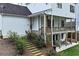 House with an outdoor patio featuring chairs, a grill, and a deck with wooden railings and stairs at 6335 Hampton Creek Dr, Cumming, GA 30041