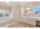 Large bathroom featuring a double vanity, large windows and a jacuzzi tub at 6335 Hampton Creek Dr, Cumming, GA 30041