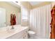 Bright bathroom featuring a white vanity with a single sink and a shower with a white curtain at 6335 Hampton Creek Dr, Cumming, GA 30041