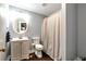 Cozy full bathroom features a toilet, vanity with sink, mirror, and neutral-toned shower curtain at 6335 Hampton Creek Dr, Cumming, GA 30041
