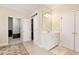 Bright bathroom features tiled floors, a large mirror, and white cabinets for a clean, modern look at 6335 Hampton Creek Dr, Cumming, GA 30041