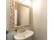 Bathroom featuring a decorative mirror, white sink, and neutral wall color at 6335 Hampton Creek Dr, Cumming, GA 30041