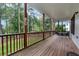 Wide, covered deck with wood flooring, railing, and outdoor seating area at 6335 Hampton Creek Dr, Cumming, GA 30041