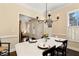 Bright dining room with a table set for dinner, featuring natural light and a view of the entrance hall at 6335 Hampton Creek Dr, Cumming, GA 30041