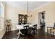 Cozy dining room featuring a dining table set for dinner, decorative cabinet and lots of natural light at 6335 Hampton Creek Dr, Cumming, GA 30041