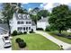 Well-maintained two-story traditional home with a lush front yard, driveway, and attached garage at 6335 Hampton Creek Dr, Cumming, GA 30041