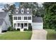 Charming two-story home featuring a well-manicured lawn, symmetrical design and an attached two car garage at 6335 Hampton Creek Dr, Cumming, GA 30041