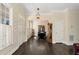 Spacious foyer with hardwood floors, leading to the dining room, showing beautiful natural light at 6335 Hampton Creek Dr, Cumming, GA 30041