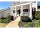 Inviting home entrance with landscaped garden and walkway leading to a covered front porch with white columns at 6335 Hampton Creek Dr, Cumming, GA 30041