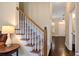 Hallway featuring carpeted stairs, wood railing, and views into other rooms at 6335 Hampton Creek Dr, Cumming, GA 30041