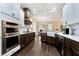 Modern kitchen with a view to the dining room, featuring stainless steel appliances, marble countertops and coffered ceiling at 6335 Hampton Creek Dr, Cumming, GA 30041