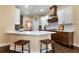 A close view of the kitchen featuring white cabinets, a breakfast bar, and stainless steel appliances at 6335 Hampton Creek Dr, Cumming, GA 30041