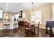 Bright kitchen with white cabinets, stainless steel appliances, a breakfast bar, and an adjacent dining area at 6335 Hampton Creek Dr, Cumming, GA 30041