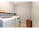 Efficient laundry room featuring front loading washer and dryer, as well as useful storage at 6335 Hampton Creek Dr, Cumming, GA 30041