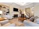 A cozy living room features a fireplace, built-in shelving, and comfortable seating for entertaining at 6335 Hampton Creek Dr, Cumming, GA 30041