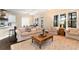 A spacious living room with a large window, comfortable seating, and dark hardwood floors throughout at 6335 Hampton Creek Dr, Cumming, GA 30041