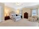Spacious main bedroom with neutral walls, carpeted floors, and natural light from the windows at 6335 Hampton Creek Dr, Cumming, GA 30041