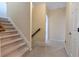 Carpeted stairway with wooden handrail leads to the next floor of the residence at 6335 Hampton Creek Dr, Cumming, GA 30041