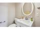 Powder room with oval mirror and a white vanity at 810 Abbotts Mill Ct # 83, Duluth, GA 30097