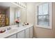 Bathroom features a double sink vanity with a large mirror and decorative fixtures at 810 Abbotts Mill Ct # 83, Duluth, GA 30097