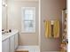 Bright bathroom features a white vanity, large mirror and tiled floor at 810 Abbotts Mill Ct # 83, Duluth, GA 30097