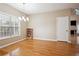 Bright dining room features hardwood floors, large window, and stylish chandelier lighting at 810 Abbotts Mill Ct # 83, Duluth, GA 30097