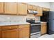 Kitchen with stainless steel appliances, light wood cabinets and neutral countertops at 810 Abbotts Mill Ct # 83, Duluth, GA 30097