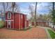 Spacious backyard with a two-story barn-like structure and a charming walkway to the main house at 875 White Sw St, Atlanta, GA 30310