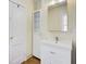 Classic bathroom featuring a bright window, vanity with storage, and large mirror at 875 White Sw St, Atlanta, GA 30310