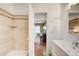 Tiled shower and a view into the main bedroom with modern fixtures and natural light at 875 White Sw St, Atlanta, GA 30310